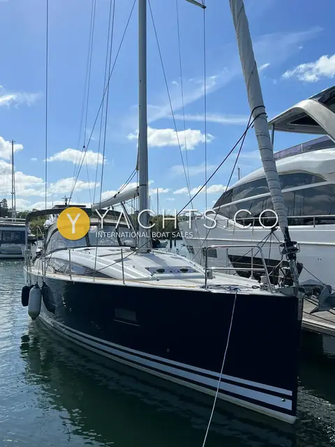 Jeanneau 51: bow view of the blue hull moored stern-to beside a large motor yacht