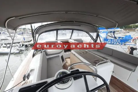 Jeanneau 51: cockpit from the helm, showing grey cushions, bimini and folding table