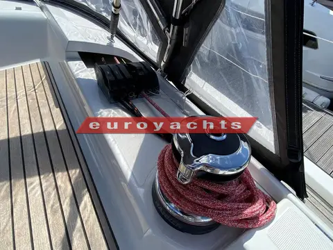 Jeanneau 51: cockpit winch with a red line wrapped round it, beside the sprayhood