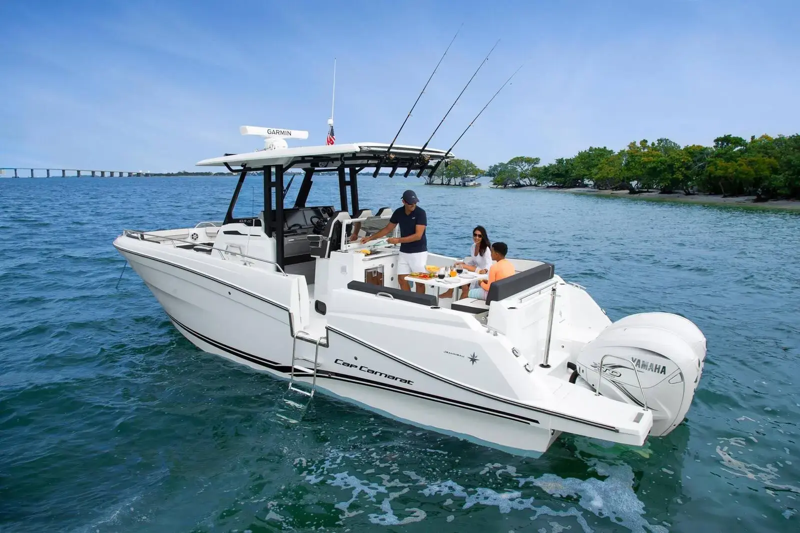 Jeanneau Cap Camarat 10.5 CC: white centre console with T-top and rod holders, guests seated in the bow cockpit at anchor