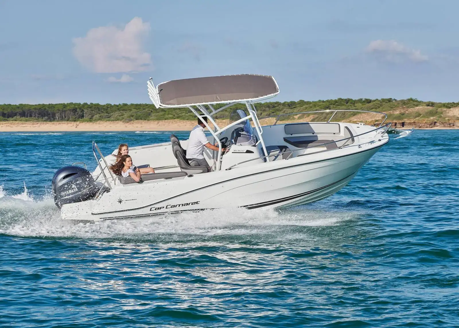 Jeanneau Cap Camarat 6.5 CC: white centre console boat under way at speed with grey T-top and single outboard