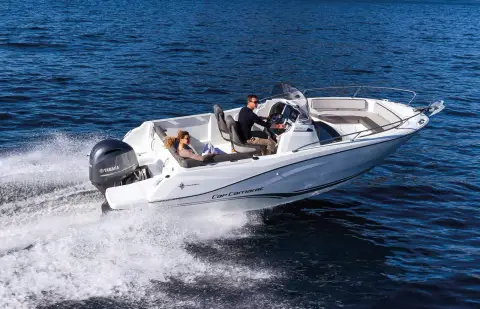 Jeanneau Cap Camarat 6.5 CC: running across open water with two aboard at the centre console helm and outboard