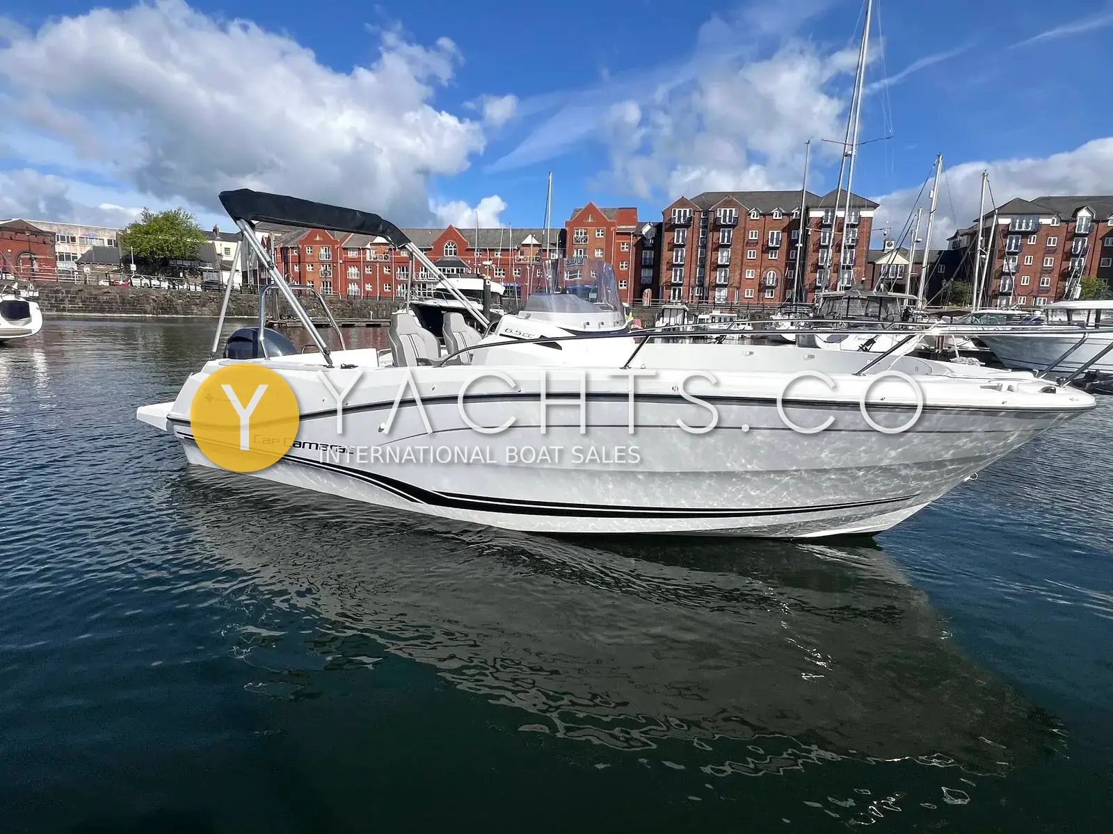 Jeanneau Cap Camarat 6.5 CC S3: starboard side view of white centre console hull with bimini, moored in Swansea marina