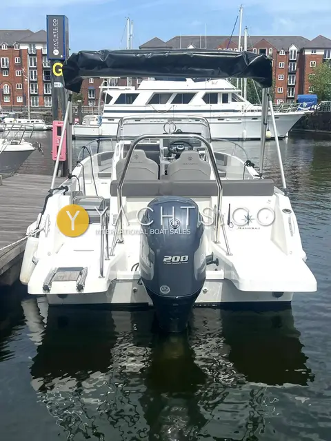 Jeanneau Cap Camarat 6.5 CC S3: stern view showing single Yamaha 200 outboard, swim platforms and bimini frame