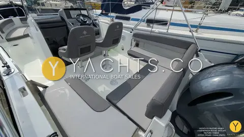 Jeanneau Cap Camarat 6.5 CC Serie 3: aft cockpit with grey cushioned benches, folding table and outboard beyond
