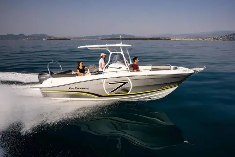 Jeanneau Cap Camarat 7.5 CC: side view under way showing white hull with yellow and grey graphics and T-top