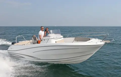 Jeanneau Cap Camarat 7.5 CC: white-hulled version without T-top running at speed, two people at the console
