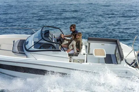 Jeanneau Cap Camarat 7.5 WA: helm with windscreen and seated driver, boat running at speed on open water