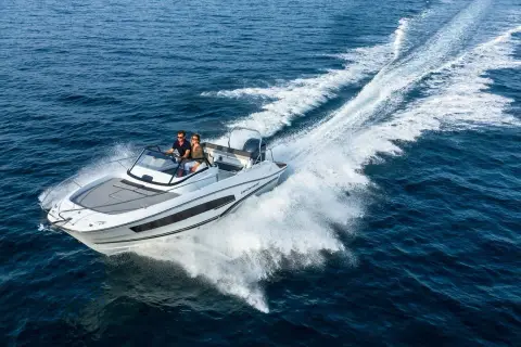 Jeanneau Cap Camarat 7.5 WA: white hull with dark side stripe planing across deep blue water, leaving a long wake