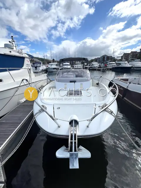 Jeanneau Cap Camarat 7.5 WA S2: bow view from the pontoon showing anchor fitting, foredeck sundeck and guardrails