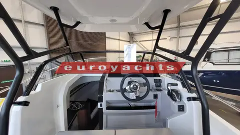 Jeanneau Cap Camarat 7.5 WA S3: helm and windscreen seen from the cockpit beneath the T-Top frame