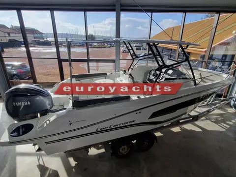 Jeanneau Cap Camarat 7.5 WA S3: boat on trailer in showroom viewed from above, Yamaha outboard on transom