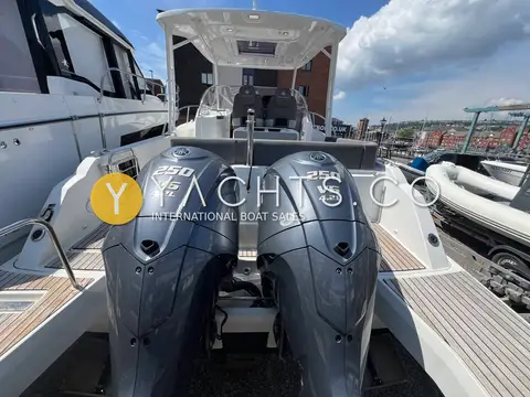 Jeanneau Cap Camarat 9.0 WA: twin black V6 outboards at the transom between teak-decked swim platforms