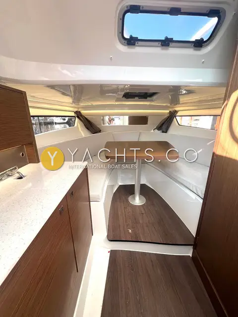 Jeanneau Cap Camarat 9.0 WA: cabin looking forward past the galley counter to the dinette table and seating