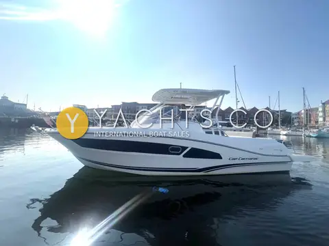 Jeanneau Cap Camarat 9.0 WA: starboard profile afloat in sunshine showing dark hull band, windscreen and white T-top