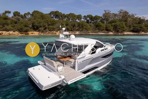 Jeanneau DB 37: starboard bow view at anchor with side terrace lowered and cockpit table set