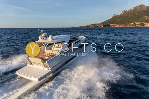 Jeanneau DB 37: running at speed at sunset with a white wake and coastal hills behind