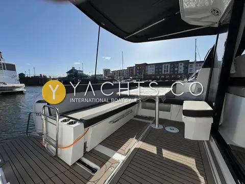 Jeanneau Merry Fisher 1095: aft cockpit with U-shaped seating, table, teak-effect decking and boarding ladder