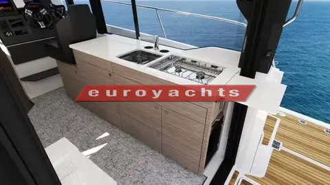 Jeanneau Merry Fisher 1095 Coupe Serie 2: galley unit with sink, hob and wood-finish cupboards beside the helm seat