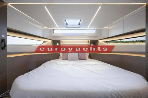 Jeanneau Merry Fisher 1295 Coupe S2: cabin with large double berth, long hull windows each side and overhead hatch