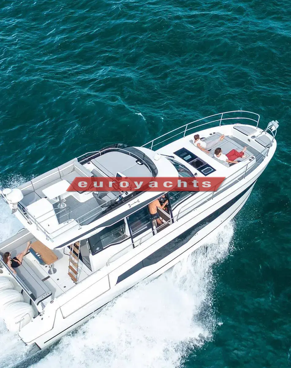 Jeanneau Merry Fisher 1295 Fly S2: aerial view underway showing flybridge seating, forward sun loungers and hull windows