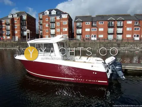 Jeanneau Merry Fisher 6 Marlin: port side profile of the claret hull and white wheelhouse moored in a marina