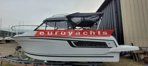 Jeanneau Merry Fisher 605: starboard side on trailer with black cockpit canvas fitted and wheelhouse windows