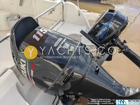 Jeanneau Merry Fisher 625: transom with black 115hp main outboard and smaller auxiliary outboard alongside