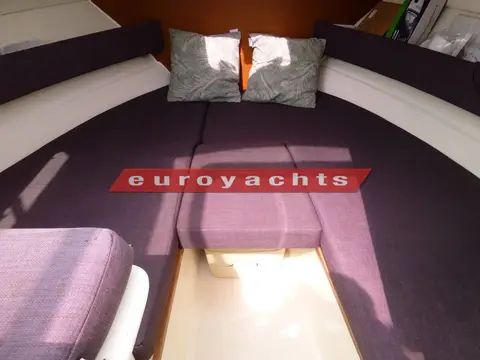 Jeanneau Merry Fisher 645: forward cabin U-shaped purple seating with cushions and infill section removed