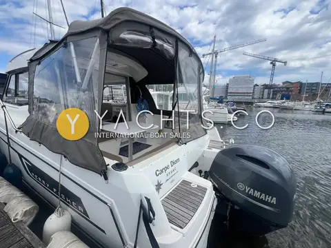 Jeanneau Merry Fisher 755: stern quarter showing the cockpit under full canvas enclosure and the Yamaha outboard