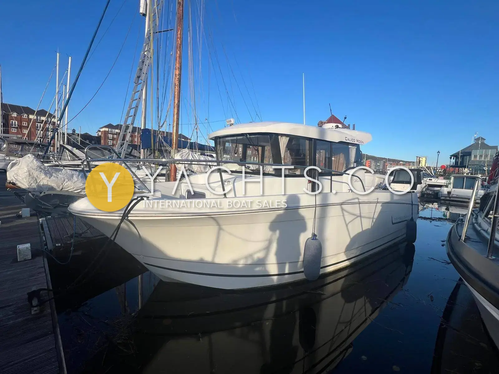 Jeanneau Merry Fisher 855 Marlin: white hull and wheelhouse moored alongside a marina pontoon on a sunny day