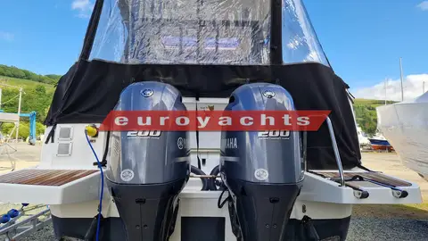 Jeanneau Merry Fisher 895 Offshore: twin grey 200hp outboards on the transom below the black cockpit canvas