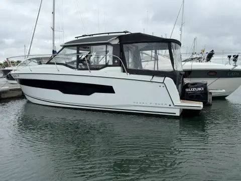 Jeanneau Merry Fisher 895 S2: starboard quarter view showing aft canvas enclosure and twin outboards on the transom