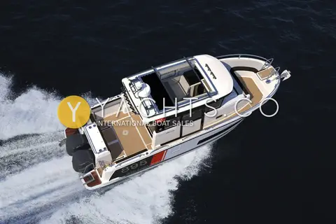 Jeanneau Merry Fisher 895 Sport Offshore: aerial view under way showing open roof hatch, teak-look cockpit and twin black outboards