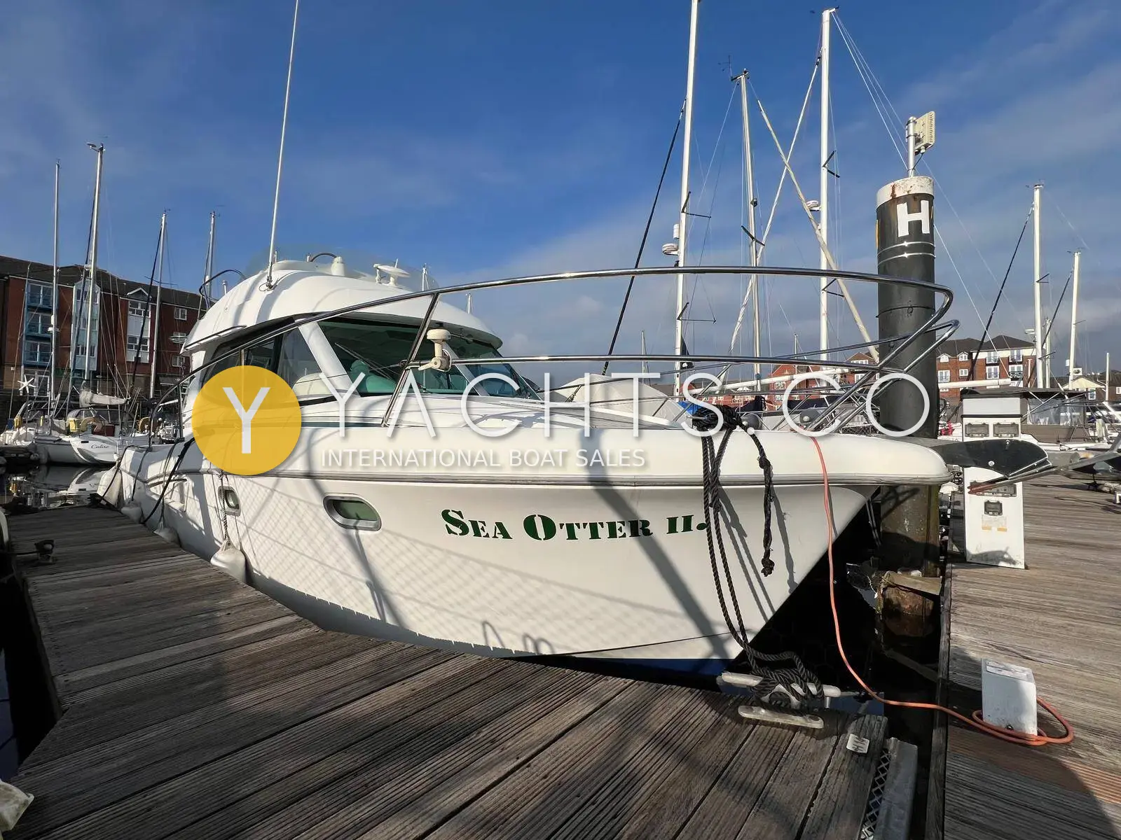 Jeanneau Merry Fisher 925: white hull and wheelhouse from the pontoon, name Sea Otter on the topsides, marina berth