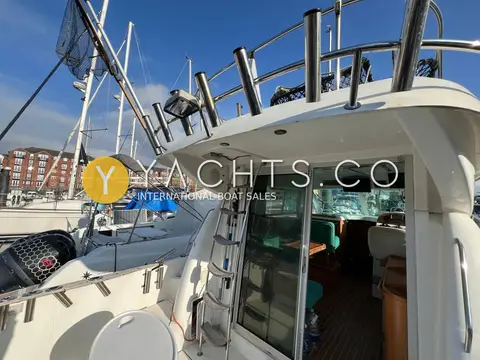 Jeanneau Merry Fisher 925: side deck by the wheelhouse door, with ladder rising to the flybridge rail