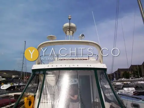 Jeanneau Prestige 36: radar arch with radome, antennas and searchlight above the enclosed cockpit canopy