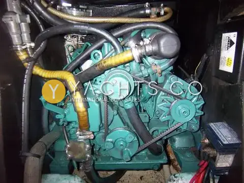 Jeanneau Sun Odyssey 32.2: engine bay showing the green Volvo inboard diesel with belts and hoses