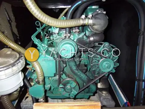 Jeanneau Sun Odyssey 34.2: engine bay with green three-cylinder diesel, alternator belt and water strainer