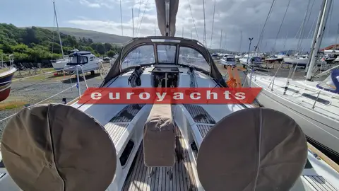 Jeanneau Sun Odyssey 349: cockpit looking forward past covered twin wheels to the sprayhood and teak cockpit table
