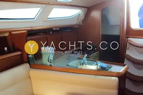 Jeanneau Sun Odyssey 35: saloon looking aft to galley with glass splash screen, sink, cooker and cream seating
