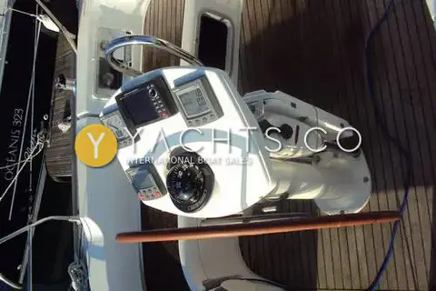 Jeanneau Sun Odyssey 35: helm pedestal with instrument displays and compass on teak cockpit sole, photo shown sideways