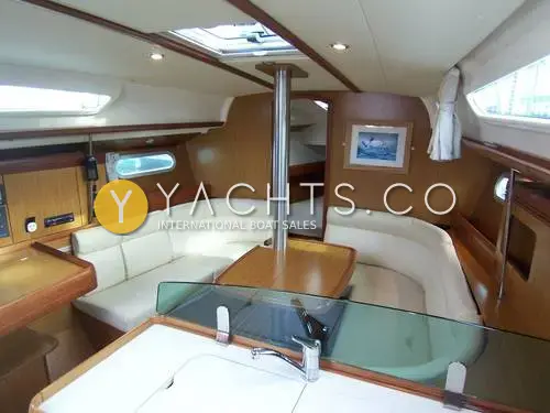 Jeanneau Sun Odyssey 36I: saloon with cream U-shaped seating, folding table and glass splash screen at the galley