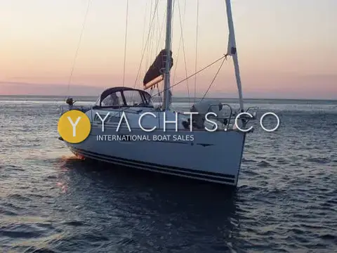Jeanneau Sun Odyssey 36I: afloat at sunset with sprayhood up and mainsail stowed on the boom