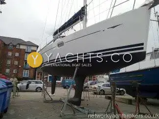 Jeanneau Sun Odyssey 36I: hull ashore on cradle in a boatyard showing keel and dark hull stripes