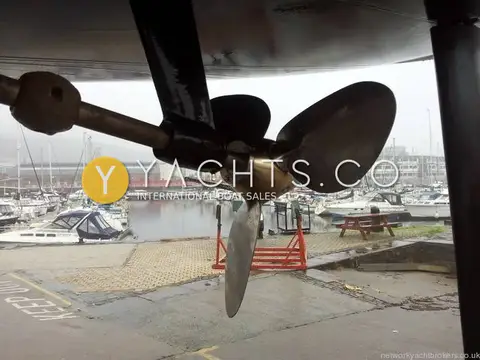 Jeanneau Sun Odyssey 36I: underwater view of three-bladed feathering propeller and shaft, marina behind
