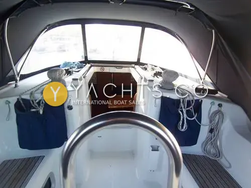 Jeanneau Sun Odyssey 37: cockpit looking forward under the spray hood towards the open companionway, with blue halyard tail bags