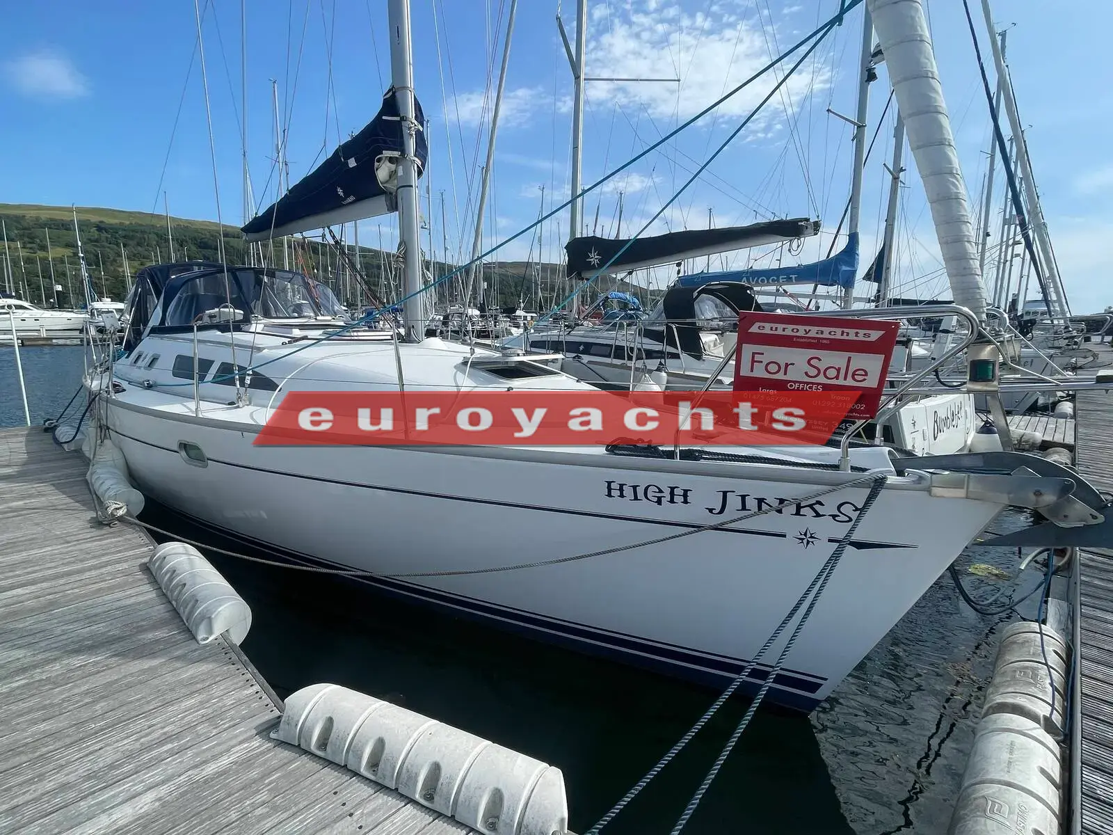 Jeanneau Sun Odyssey 37 Legende: white hull alongside a pontoon with fenders out, name visible on the bow