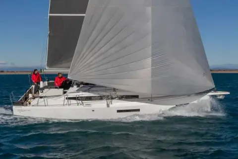 Jeanneau Sun Odyssey 380: sailing close-hauled under grey mainsail and genoa with crew in the cockpit