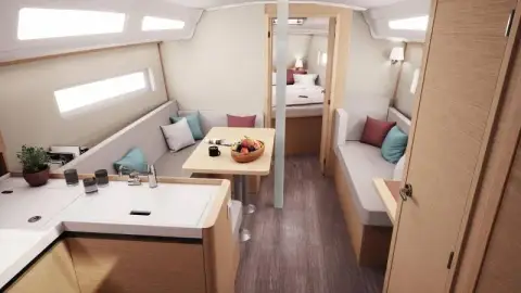 Jeanneau Sun Odyssey 380: saloon looking aft with settees either side, central dining table and galley to the left